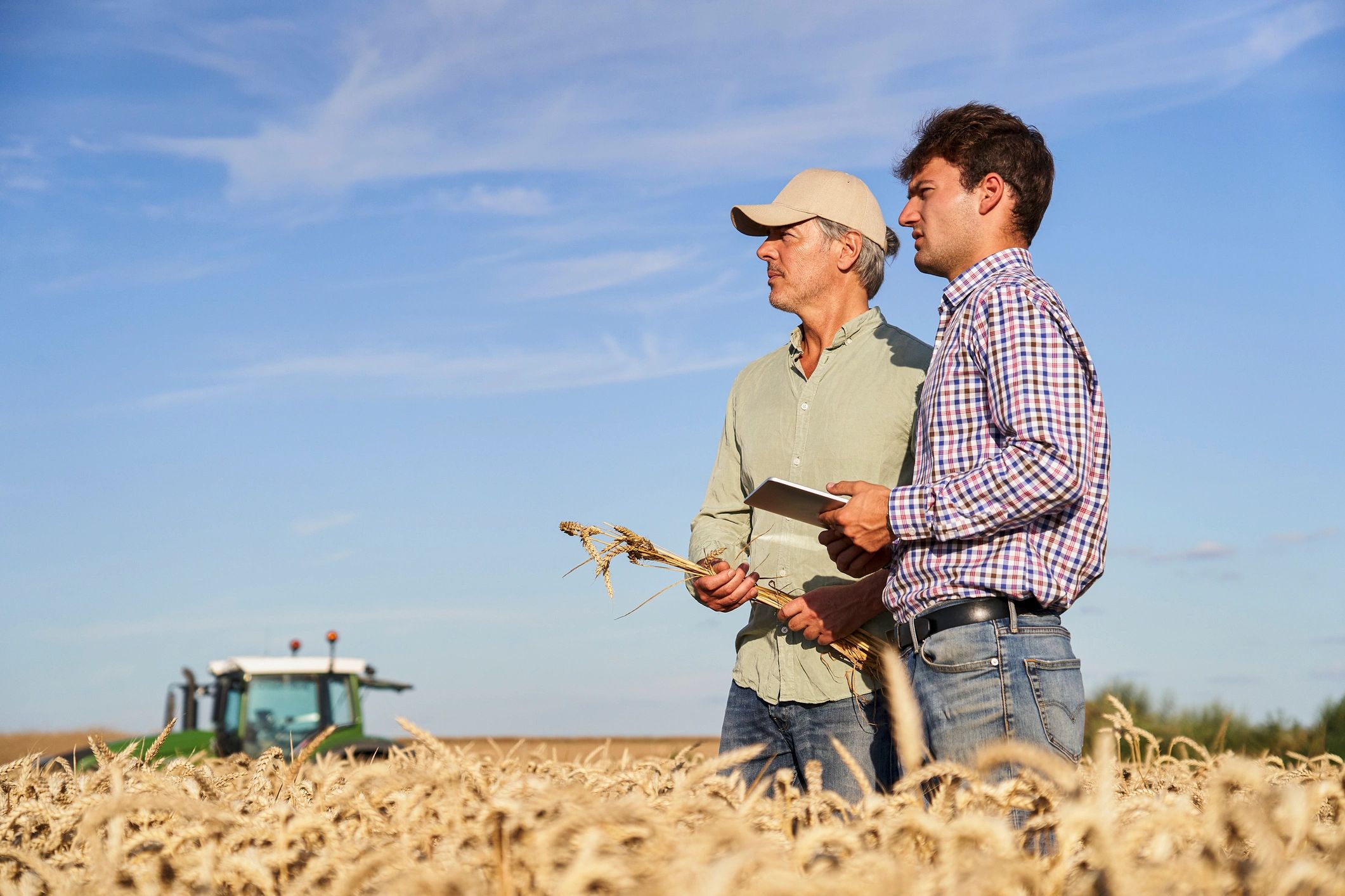 Agricultural advisor and farmer reviewing crop performance in the field